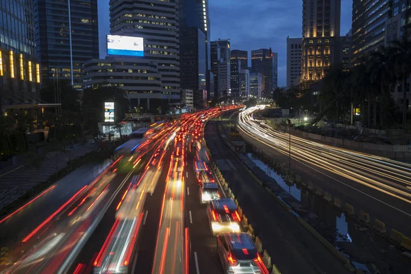 Glowing lights from hectic traffic on the road — Stock Photo, Image