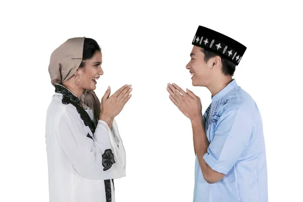 Muslim couple gives a greeting hand on studio — Stock Photo, Image