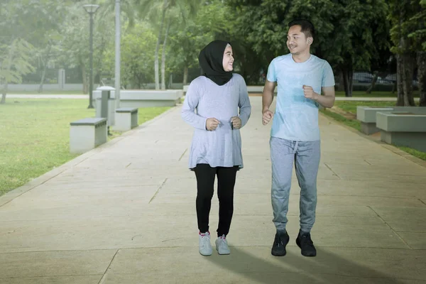 Muslimský pár spolu v parku běhají — Stock fotografie
