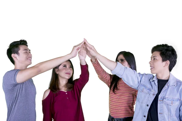 Quatro estudantes universitários fazendo altos cinco gestos — Fotografia de Stock