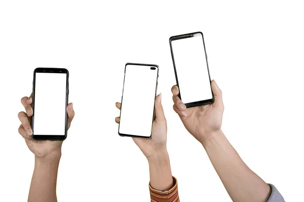 Руки трех человек поднимают телефоны на студию — стоковое фото