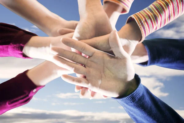 Young people put their hands together — Stock Photo, Image