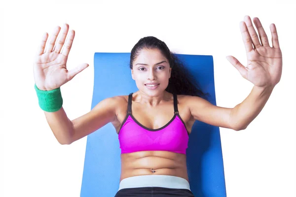 Indian woman doing abdominal sit ups on studio — Stock Photo, Image