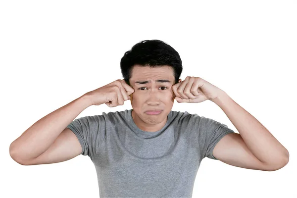 Young Asian man crying in the studio — Stock Photo, Image