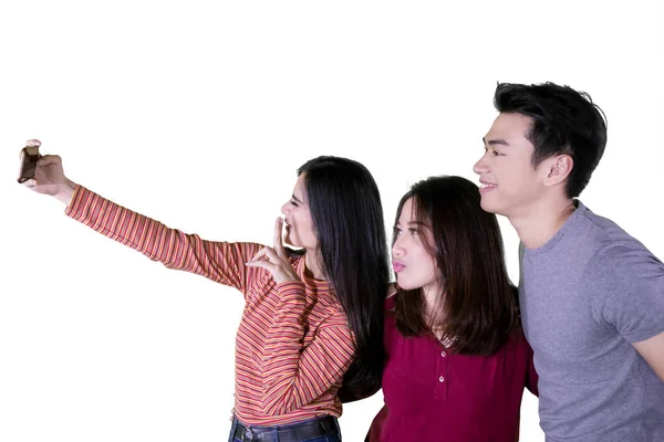 Young people taking selfie together on studio — Stock Photo, Image
