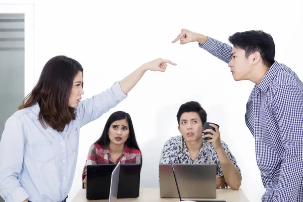 Two angry people accuse each other in the meeting