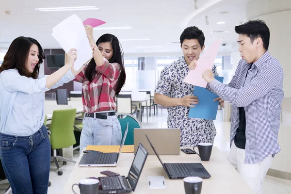 Happy business people dance with paperwork — Stock Photo, Image