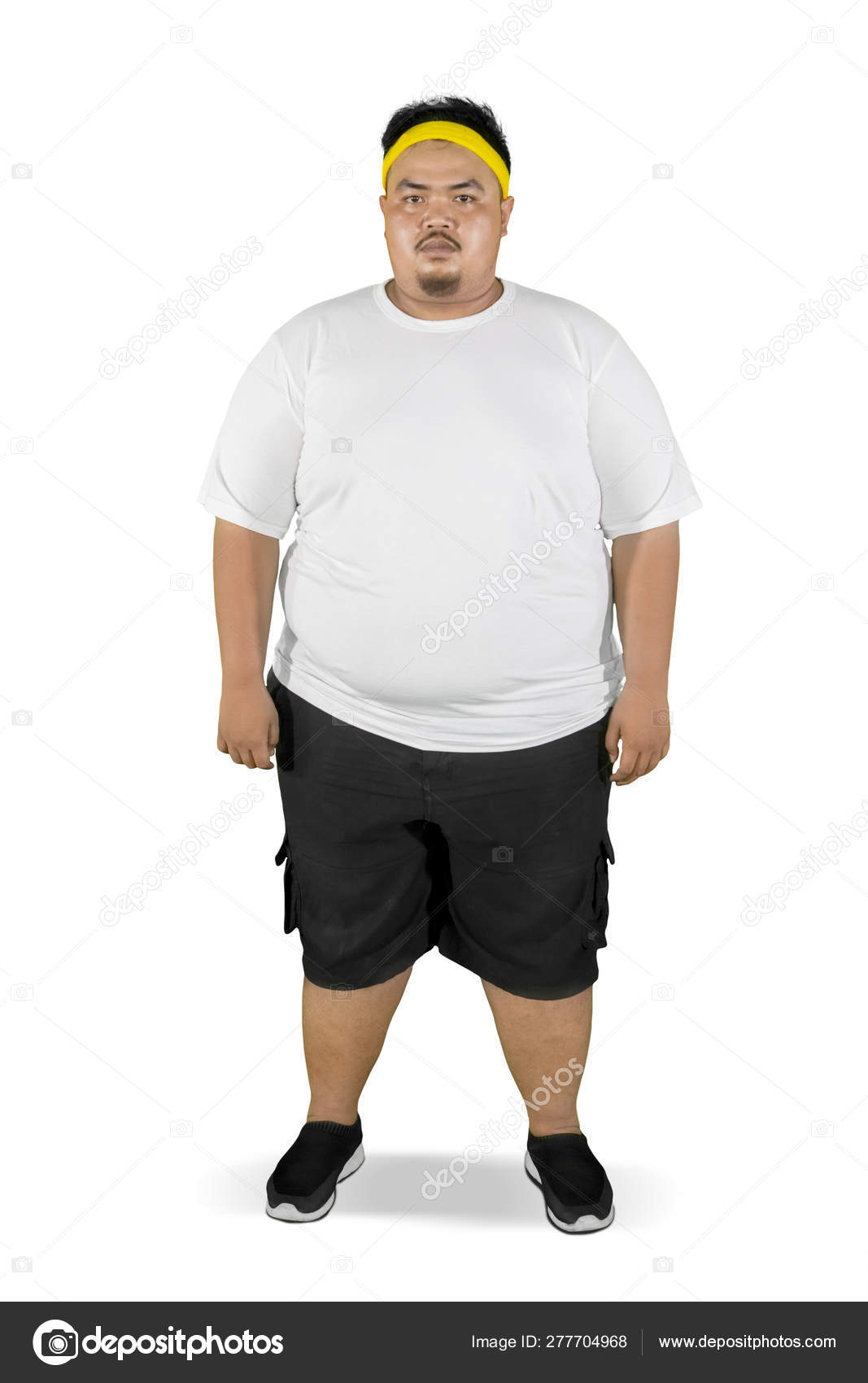 Fat man stands with confused expression on studio — Stock Photo