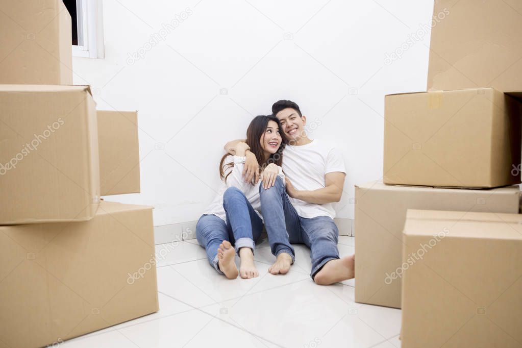 Asian couple enjoying rest time in the new house