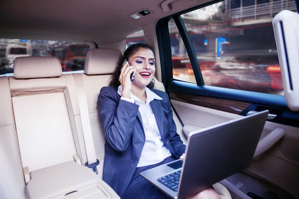 Businesswoman works with laptop in car — Stock Photo, Image