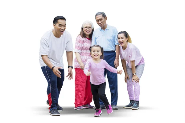 Happy little girl playing with her family on studio — Stock Photo, Image