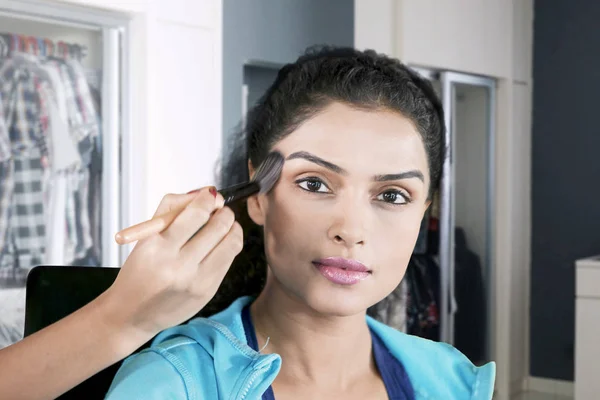 Modell appliceras pulver av hennes makeup artist — Stockfoto