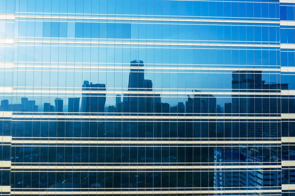 Windows of high building reflect Jakarta cityscape — Stock Photo, Image