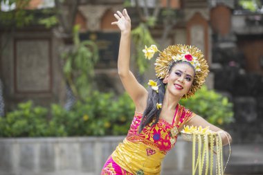 Güzel Bali dansçı frangipani çiçek atar