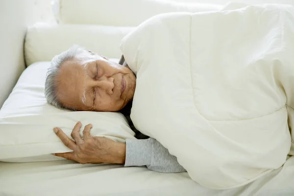 Old man sleeping well on the bed