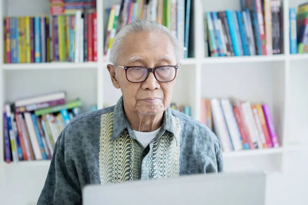 Happy old man wearing sunglasses on studio