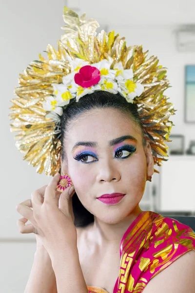 Young balinese dancer wears earrings accessories