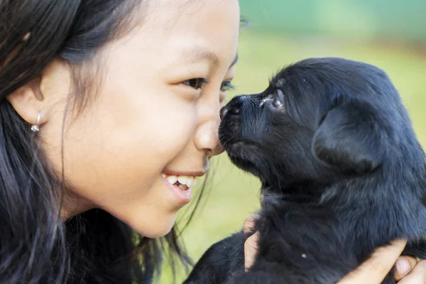 Little girl holding her puppy at outdoor — Stock Photo, Image