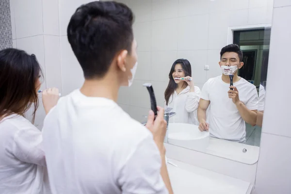 Young husband checking temperature of his wife — Stock Photo, Image