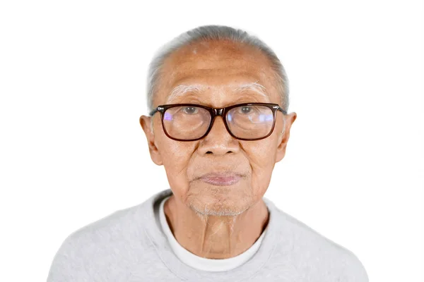 Elderly man wearing eyeglasses in the studio — Stock Photo, Image