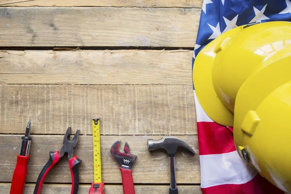 Construction tools and American flag on table — Stock Photo, Image