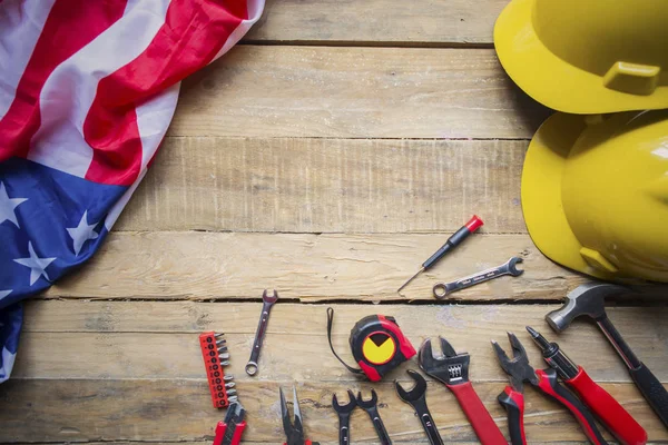 Two helmets with tools and American flag on table — Stock Photo, Image