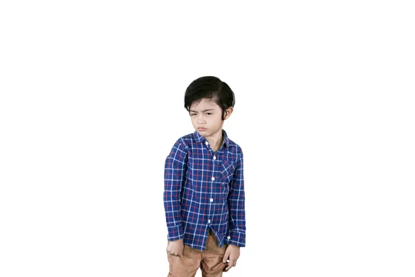 Boy looking at the camera with arrogant expression — Stock Photo, Image