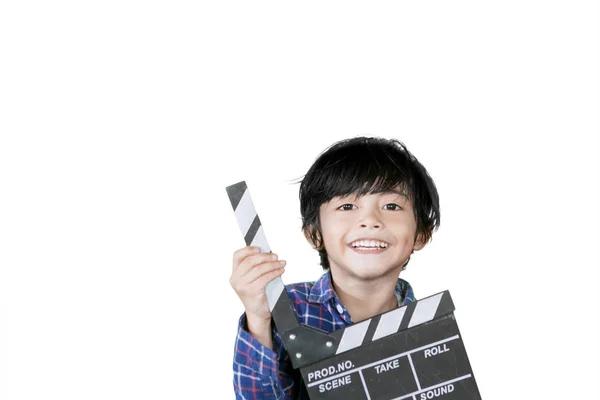 Cute little boy holding a clapperboard on studio — Stock Photo, Image