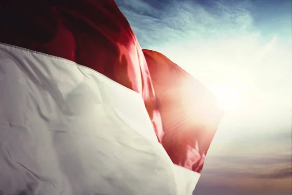 Indonesia flag blowing with sunrise background — Stock Photo, Image