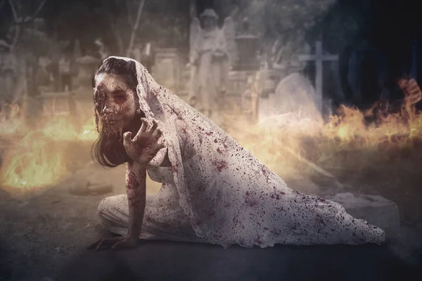 Bride ghost crawling in the burning cemetery — Stock Photo, Image