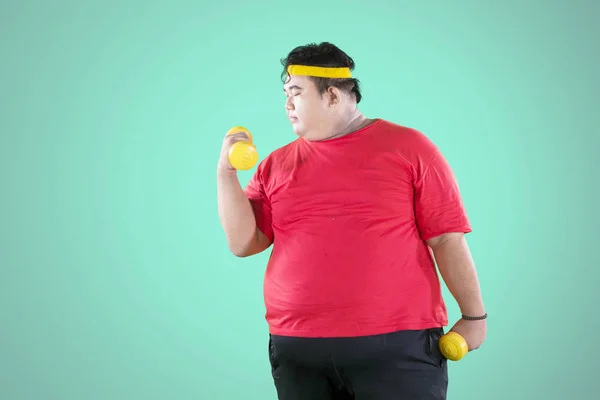Overweight man kicking soft drink and fast food — Stock Photo, Image