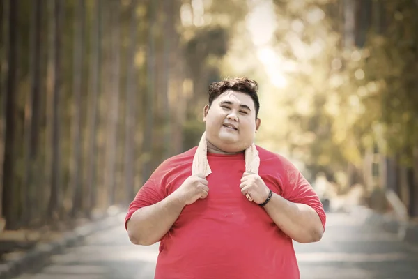 Overweight man kicking soft drink and fast food — Stock Photo, Image