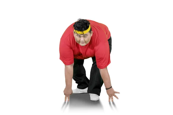 Young fat man looks tired after exercises on studio — Stock Photo, Image