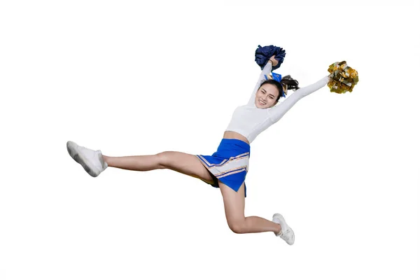 Happy cheerleader girl lifting pom poms on studio — Stock Photo, Image