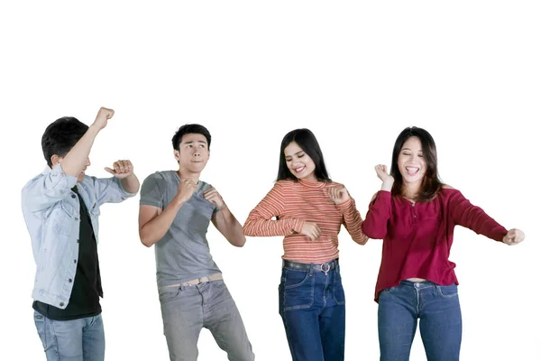 Group of happy teenagers dancing together on studio — Stock Photo, Image