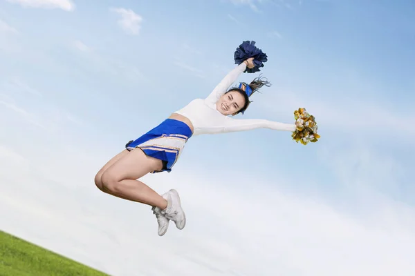 Pretty cheerleader girl jumping with pom poms — 스톡 사진