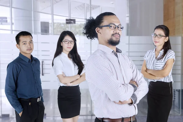Business people stands with folded arms in office — Stock Photo, Image