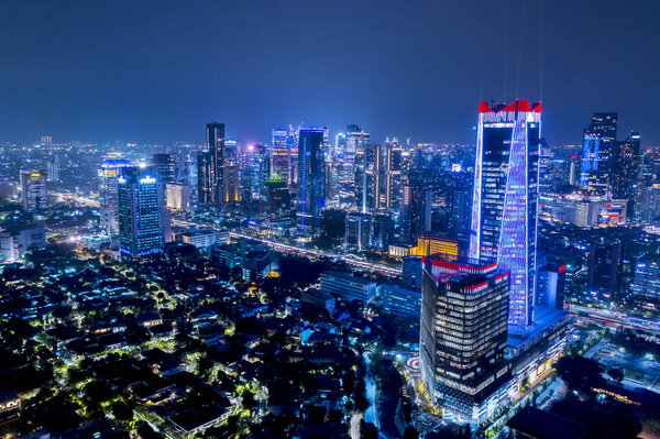 JAKARTA - Indonesia. October 08, 2019: Exotic aerial view of Jakarta city with glowing skyscrapers and night lights