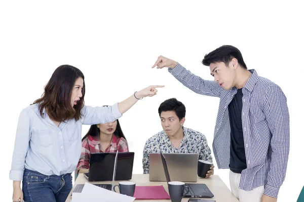 Two angry workers pointing each other on studio