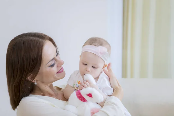 Happy woman holding her cute baby at home — Stock Photo, Image