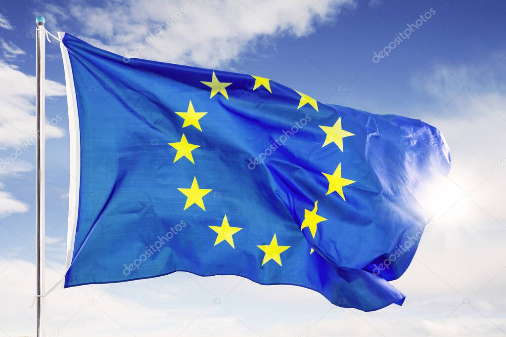 European Union flag fluttering under blue sky