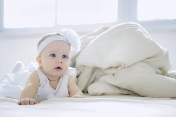 Piękne dziecko dziewczynka czołga się na łóżku — Zdjęcie stockowe