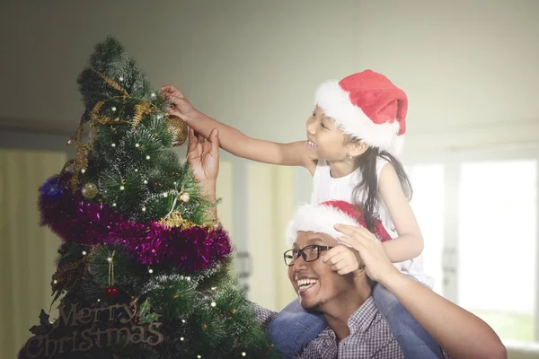 Apa és lánya díszítik a karácsonyfát — Stock Fotó