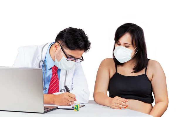 Male Doctor Wearing Face Mask While Writing Prescription His Pregnant — Stock Photo, Image