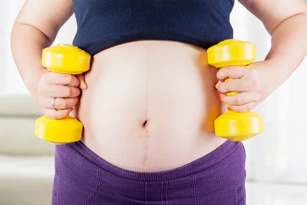 Close Pregnant Woman Tummy Doing Workout Two Dumbbells Standing Living — Stock Photo, Image