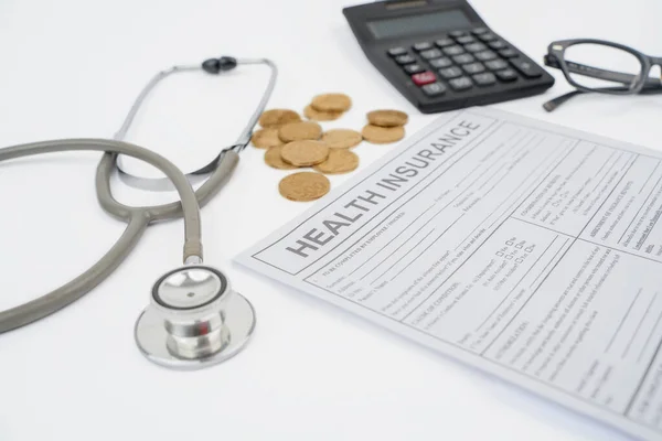 Health Insurance Claim Form Golden Coins Stethoscope Calculator Pen Table — Stock Photo, Image