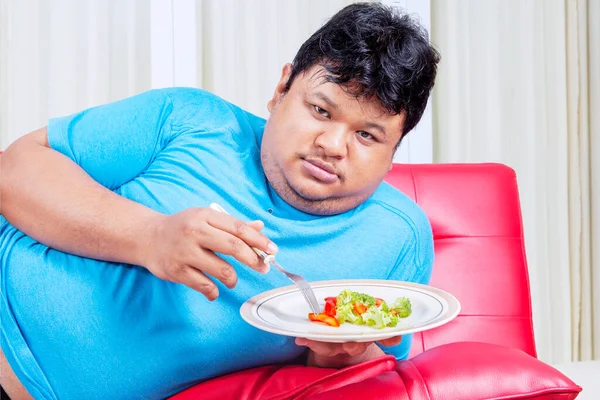 Close Obesity Man Hating Eats Healthy Food While Lying Sofa — Stock Photo, Image