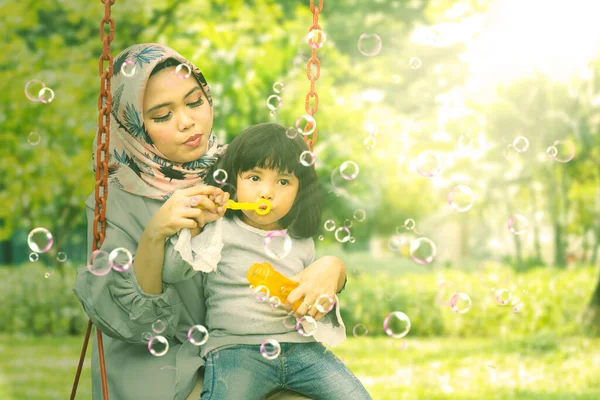 Happy Little Girl Playing Soap Bubble Her Mother While Sitting — Stock Photo, Image