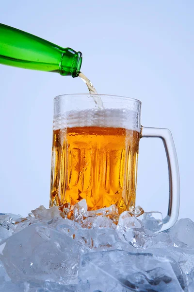Closeup Green Bottle Pouring Cold Beer Glass Stack Ice Cubes — Stock Photo, Image