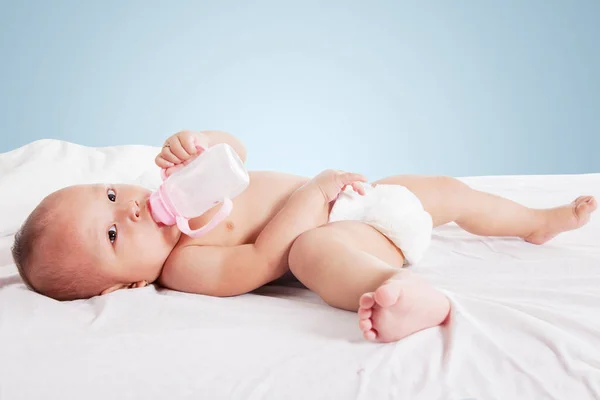 Close Beautiful Baby Girl Drinking Milk Bottle While Lying Bed — Stock Photo, Image